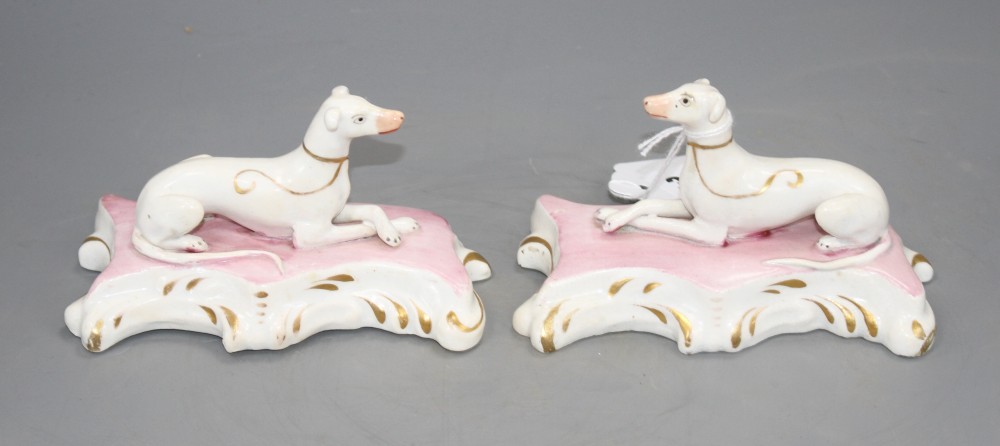 A pair of Staffordshire porcelain figures of recumbent greyhounds, c.1835-50, L. 12.2cm